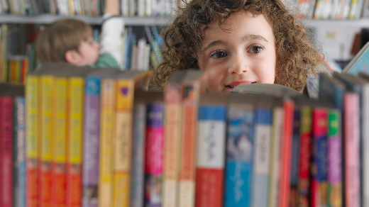 Students looking a books on a library books